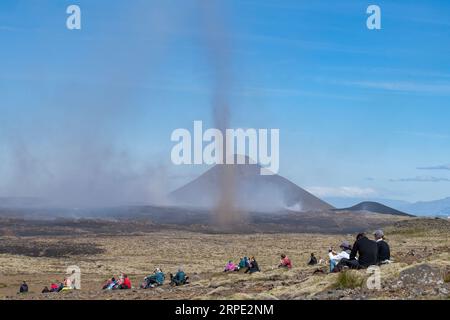 Grindavik, Islanda-28 luglio 2023; persone che osservano fessure vicino alla collina di Litli-Hrútur durante l'eruzione del 2023 vicino alla montagna Fagradalsfjall con la moun subglaciale Foto Stock