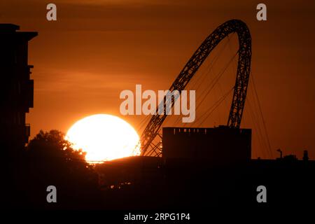 Il sole tramonta dietro l'Arch Wembley Stadium, a ovest di Londra. Data immagine: Lunedì 4 settembre 2023. Foto Stock