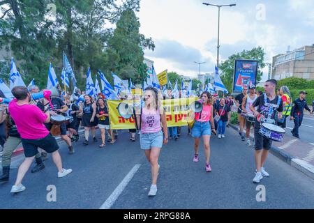 Haifa, Israele - 02 settembre 2023: La gente marcia con vari segni e bandiere, guidati da educatori. Settimana 35 di protesta contro controversa ove giudiziaria Foto Stock