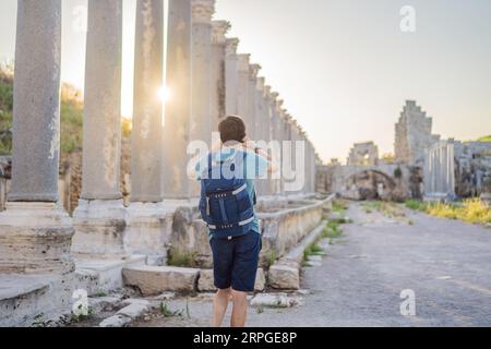 Turista presso le rovine dell'antica città di Perge vicino ad Antalya in Turchia Foto Stock