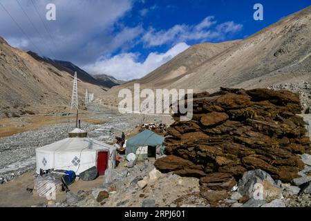 191128 -- TAXKORGAN, 28 novembre 2019 -- foto scattata il 13 novembre 2019 mostra linee di trasmissione di energia a 35 kV che attraversano una valle nella Maryang Township, Taxkorgan, nella regione autonoma di Xinjiang Uygur della Cina nord-occidentale. Maryang Township e Datong Township si trovano nel Pamir Plateau, tra alte montagne e profonde valli, lontano dal capoluogo della contea. Per molto tempo, il terreno causa il lento sviluppo di energia e altre infrastrutture, che è diventato il principale ostacolo per la riduzione della povertà locale. Anche i pannelli fotovoltaici impostati dal governo possono Foto Stock