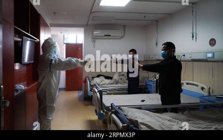 200218 -- NANCHANG, 18 febbraio 2020 -- Uno staff medico conduce i pazienti a fare esercizio in un reparto dell'ospedale affiliato dell'Università Jiangxi di Medicina tradizionale Cinese a Nanchang, provincia di Jiangxi, Cina orientale, 18 febbraio 2020. Durante la lotta contro il nuovo coronavirus, l'ospedale affiliato della Jiangxi University of Traditional Chinese Medicine intensifica gli sforzi per portare avanti il trattamento della medicina tradizionale cinese MTC per i pazienti infettati dal nuovo coronavirus. La medicina occidentale offre importanti misure di sostegno alla vita, come l'assistenza respiratoria e circolatoria, Foto Stock