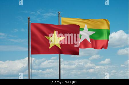 Myanmar, ovvero bandiera birmana e bandiera del Vietnam, che sventolano insieme sul cielo blu, concetto di cooperazione tra due paesi Foto Stock