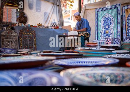 Laboratorio di artigianato marocchino, insieme a un lavoratore sullo sfondo, circondato dai loro prodotti. Fotografia scattata il 2 settembre 2023 nella città di Av Foto Stock