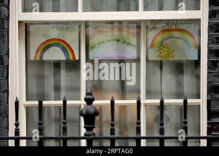 200413 -- LONDRA, 13 aprile 2020 Xinhua -- immagini di arcobaleni con messaggi di supporto sono viste nella finestra di 10 Downing Street a Londra, in Gran Bretagna, 13 aprile 2020. Il bilancio delle vittime di coloro che sono stati ricoverati in Gran Bretagna che sono risultati positivi per il nuovo coronavirus ha raggiunto 10.612 a partire da sabato pomeriggio, il Dipartimento di salute e assistenza sociale ha detto domenica. Foto di Tim Ireland/Xinhua BRITAIN-LONDON-COVID-19-DEATH TOLL PUBLICATIONxNOTxINxCHN Foto Stock