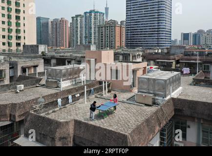 200415 -- PECHINO, 15 aprile 2020 -- foto aerea scattata il 10 aprile 2020 mostra i bambini che giocano a ping pong sul tetto di un edificio residenziale a Guangzhou, nella provincia del Guangdong della Cina meridionale. XINHUA FOTO DEL GIORNO LiuxDawei PUBLICATIONxNOTxINxCHN Foto Stock