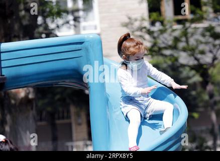 200514 -- PECHINO, 14 maggio 2020 -- Una ragazza che indossa una maschera gioca in un parco giochi ad Ankara, Turchia, 13 maggio 2020. I bambini al di sotto dei 14 anni in Turchia sono stati ammessi all'esterno il 13 maggio per la prima volta in 40 giorni come parte del piano di normalizzazione COVID-19 del paese. Foto di /Xinhua XINHUA FOTO DEL GIORNO MustafaxKaya PUBLICATIONxNOTxINxCHN Foto Stock