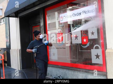 200608 -- NEW YORK, 8 giugno 2020 -- Un lavoratore pulisce la finestra dell'ufficio di ritiro ordini online di Macy's a Manhattan, New York, negli Stati Uniti, 8 giugno 2020. Dopo quasi tre mesi di confinamento, New York è entrata nella prima fase di riapertura lunedì, 100 giorni da quando la città ha segnalato il suo primo caso di COVID-19. U.S.-NEW YORK CITY-COVID-19-RIAPERTURA WANGXYING PUBLICATIONXNOTXINXCHN Foto Stock