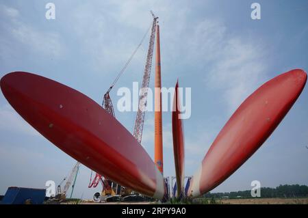 200621 -- QINHUANGDAO, 21 giugno 2020 -- foto scattata il 20 giugno 2020 mostra il cantiere della seconda fase di un progetto di energia eolica nella contea di Changli di Qinhuangdao, nella provincia di Hebei nella Cina settentrionale. Il sollevamento e l'installazione di turbine eoliche nella seconda fase del progetto di energia eolica sono ufficialmente iniziati di recente. Il progetto di energia eolica, con un investimento pianificato di 1,696 miliardi di yuan circa 240 milioni di dollari americani, sarà costruito in due fasi. Dopo il completamento dell'intero progetto, sarà in grado di generare 600 milioni di kilowattora di energia all'anno. CINA Foto Stock