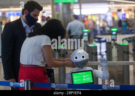 200628 -- ATENE, 28 giugno 2020 -- i membri dello staff dell'aeroporto internazionale di Atene mettono una maschera facciale su un robot Pepper ad Atene, Grecia, 26 giugno 2020. DA AGGIUNGERE: Caratteristica: L’aeroporto internazionale di Atene recluta robot per informare i viaggiatori sulle misure COVID-19 GRECIA-ATENE-AEROPORTO-ROBOT-COVID-19 MariosxLolos PUBLICATIONxNOTxINxCHN Foto Stock