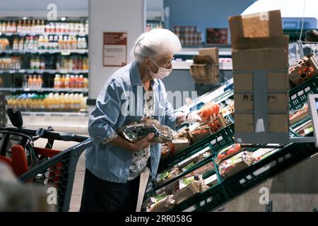 200729 -- BRUXELLES, 29 luglio 2020 -- Un cliente che indossa una maschera facciale negozi in un supermercato a Bruxelles, Belgio, 29 luglio 2020. Lunedì il primo ministro belga Sophie Wilmes ha annunciato nuove misure anti-COVID-19 adottate dal Consiglio di sicurezza nazionale NSC per evitare di imporre nuovamente un blocco generale nel paese. A partire da luglio 29 e per un minimo di quattro settimane, il numero di persone in una bolla di contatto sociale che attualmente è a 15 sarà ridotto a cinque per ogni famiglia. I bambini sotto i 12 anni non sono inclusi. BELGIO-BRUXELLES-COVID-19-LOCKDOWN-NEW STEPS ZHANGXCHENG PUBLICATIONXNOTXI Foto Stock