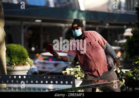 201107 -- NEW YORK, 7 novembre 2020 -- Un uomo che indossa una maschera gioca a ping pong al Bryant Park di New York, negli Stati Uniti, 6 novembre 2020. Gli Stati Uniti hanno stabilito un nuovo record mondiale poiché i loro casi di COVID-19 in un solo giorno hanno superato i 110.000 di giovedì. U.S.-NEW YORK-COVID-19-CASI WangxYing PUBLICATIONxNOTxINxCHN Foto Stock