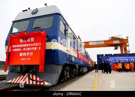 201121 -- ZHENGZHOU, 21 novembre 2020 -- Un treno merci Cina-Europa diretto a Helsinki, Finlandia attende la partenza alla stazione Putian di Zhengzhou, provincia di Henan, Cina centrale, 20 novembre 2020. Venerdì mattina è stato lanciato un nuovo treno merci Cina-Europa che collega il centro di trasporto cinese Zhengzhou e Helsinki in Finlandia. Il treno che trasportava 43 contenitori, che conteneva merci tra cui maschere mediche usa e getta, attrezzature mediche e tute da nocciola, partì intorno alle 10:40 del venerdì dalla stazione Putian di Zhengzhou. Il carico totale pesa 461 tonnellate, per un valore di circa 3 milioni di dollari Foto Stock