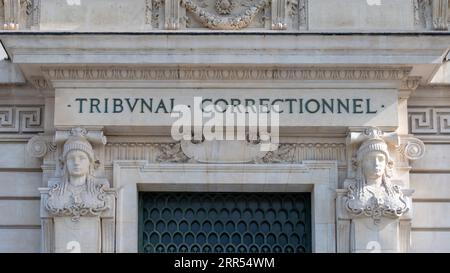 Primo piano del cartello scritto su una facciata del tribunale di Parigi, con le parole "Tribunal correctionnel" (cioè "Tribunale penale") scritte in francese Foto Stock