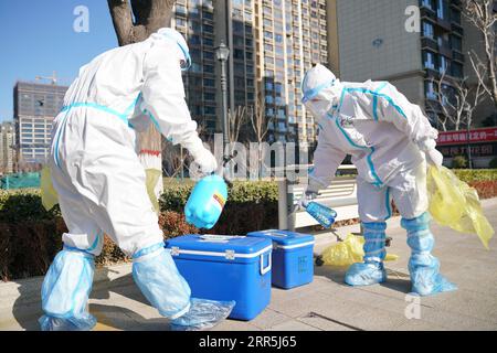 210108 -- SHIJIAZHUANG, 8 gennaio 2021 -- Mei Yiqi R disinfetta scatole contenenti campioni di acido nucleico fuori da una comunità a Shijiazhuang, provincia di Hebei, 8 gennaio 2021. Mei Yiqi, 30 anni, che lavora nel dipartimento logistico di Wuhan KingMed Diagnostics Group Co., Ltd., ha salutato la sua famiglia mercoledì e ha preso un treno ad alta velocità da Wuhan a Shijiazhuang per aiutare a combattere la pandemia di COVID-19. Nel 2020 Mei ha partecipato al lavoro anti-pandemia a Wuhan e Chengdu, assumendo successivamente la responsabilità della raccolta e del trasporto di campioni di test per la COVID-19 nel WUH Foto Stock