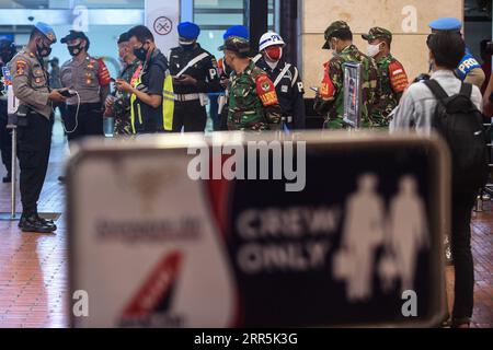 210109 -- GIACARTA, 9 gennaio 2021 -- ufficiali di polizia indonesiani e esercito stanno di guardia al centro di crisi del volo SJ-182 all'aeroporto internazionale Soekarno-Hatta di Giacarta, Indonesia, 9 gennaio 2021. Un aereo passeggeri della Sriwijaya Air indonesiana con oltre 60 persone si è schiantato nelle acque al largo di Giacarta sabato. Parti del corpo umano e detriti dell'aereo sono stati trovati, il capitano Eko Surya Hadi, comandante della nave della guardia costiera Trisula, ha detto a una TV locale. L'aereo Boeing 737-500 trasportava 62 persone, tra cui 56 passeggeri e sei membri dell'equipaggio. AGUNG KUNCAHYA B INDONESIA-SRIWIJAYA INCIDENTE AEREO A Foto Stock