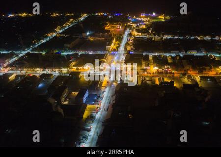 210113 -- MOHE, 13 gennaio 2021 -- foto aerea scattata il 12 gennaio 2021 mostra la vista notturna del villaggio Beiji nella città di Mohe, nella provincia di Heilongjiang nella Cina nordorientale. Il villaggio Beiji, situato nella città di Mohe, la città più settentrionale della Cina, poteva fare affidamento solo su piccoli generatori diesel per l'alimentazione elettrica prima del 2007. Dopo il collegamento alla rete di stato, il villaggio Beiji ha istituito la centrale elettrica più settentrionale della Cina, la stazione di alimentazione Beiji. Il direttore LYU Jiansheng e il lettore di contatori Wang Shaoting sono gli unici due membri dello staff della stazione che è responsabile di più di 20 chilometri di altezza Foto Stock