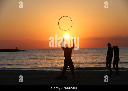 210127 -- PECHINO, 27 gennaio 2021 -- Un uomo gioca sulla spiaggia mediterranea al tramonto a Tel Aviv, Israele, il 25 gennaio 2021. XINHUA FOTO DEL GIORNO MuammarxAwad PUBLICATIONxNOTxINxCHN Foto Stock