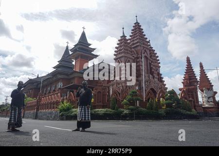 210314 -- BALI, 14 marzo 2021 -- due funzionari della sicurezza stanno di guardia in strada durante il giorno di Nyepi, o il giorno del silenzio, in mezzo all'epidemia di COVID-19 a Denpasar, Bali, Indonesia, 14 marzo 2021. Nyepi segna il capodanno del calendario balinese Saka in Indonesia. In questa festività pubblica, la gente del posto si dedica al digiuno e alla meditazione, astenendosi da pratiche come l'accensione di fuochi, il lavoro, i viaggi e l'intrattenimento. Foto di /Xinhua INDONESIA-BALI-COVID-19-NYEPI DAY Bisinglasi PUBLICATIONxNOTxINxCHN Foto Stock