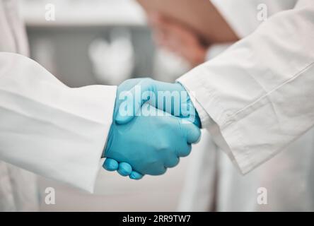 Primo piano, medico e ricerca con stretta di mano, persone e accordo con promozione, cooperazione e partenariato. Lavoro di squadra, scienziati e personale che tremano Foto Stock