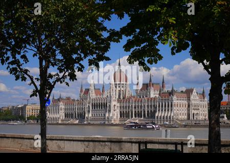 L'edificio neo-gotico del parlamento dall'altra parte del Danubio, progettato da Imre Steindl nel 1885, Budapest, Ungheria Foto Stock