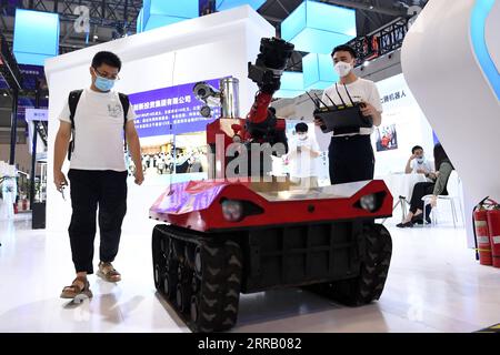 210823 -- CHONGQING, 23 agosto 2021 -- Un membro dello staff R mostra un robot per l'estinzione e il rilevamento degli incendi allo Smart China Expo di Chongqing, nel sud-ovest della Cina, 23 agosto 2021. Lo Smart China Expo 2021 ha aperto lunedì a Chongqing, con oltre 600 aziende che partecipano alla fiera online e offline. CHINA-CHONGQING-SMART CHINA EXPO CN TANGXYI PUBLICATIONXNOTXINXCHN Foto Stock