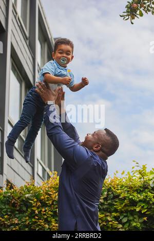 Tilst, Danimarca, 12 agosto: Padre che gioca con Son in cortile Foto Stock