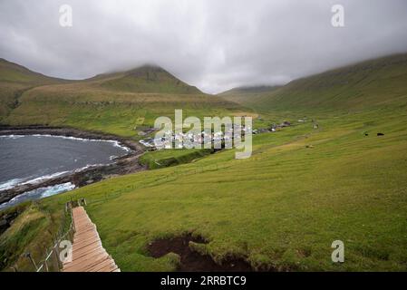 Il piccolo villaggio di Gjogv e la sua chiesa affollano il mare nell'angolo nord-est dell'isola di Eysturoy nelle Isole Faroe. Foto Stock