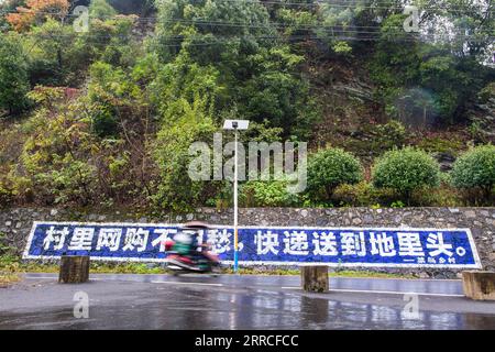 211104 -- LEIYANG, 4 novembre 2021 -- Hu Xia sta andando a consegnare i pacchi nel villaggio Shishi di Huangshi Town a Leiyang, nella Cina centrale, nella provincia di Hunan, 3 novembre 2021. HU Xia è una deliverywoman post-90 che fornisce servizio di consegna per quattro villaggi nella città di Huangshi. Negli ultimi sette anni, il numero di ordini di consegna locali nelle zone rurali è aumentato da meno di 10 al giorno a più di 200. Oltre alla consegna dei pacchetti, Hu aiuta anche gli abitanti del villaggio a vendere germogli di bambù, uova e altre specialità agricole attraverso il negozio online. La sua stazione di consegna è diventata uno dei luoghi più vivaci Foto Stock