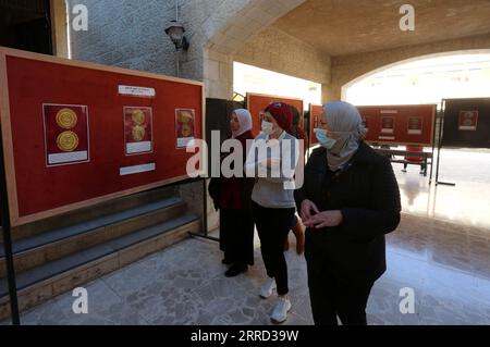 211129 -- NABLUS, 29 novembre 2021 -- le persone visitano una mostra di monete scoperte nell'area palestinese presso la An-Najah National University nella città di Nablus in Cisgiordania il 29 novembre 2021. Foto di /Xinhua MIDEAST-NABLUS-COINS-EXHIBITION NidalxEshtayeh PUBLICATIONxNOTxINxCHN Foto Stock