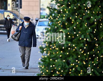 211201 -- PECHINO, 1 dicembre 2021 -- Un uomo che indossa una maschera cammina per strada a Roma, Italia, 30 novembre 2021. Titoli Xinhua: La solidarietà nel bisogno come la diffusione di Omicron mette il mondo al limite JinxMamengni PUBLICATIONxNOTxINxCHN Foto Stock