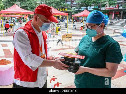 220318 -- QUANZHOU, 18 marzo 2022 -- Un volontario invia un pranzo agli operatori sanitari in un sito di test COVID-19 a Quanzhou, provincia del Fujian della Cina sud-orientale, 18 marzo 2022. Quasi 50 ristoranti a Quanzhou hanno volontariamente istituito un'alleanza per offrire un pranzo gratuito alle persone che lavorano in prima linea nella prevenzione e nel controllo della COVID-19, un modo per mostrare il loro sostegno alla lotta della città contro l'epidemia. Foto di /Xinhua CHINA-FUJIAN-QUANZHOU-VOLONTARIATO-PRANZO LIBERO CN ZhouxYi PUBLICATIONxNOTxINxCHN Foto Stock