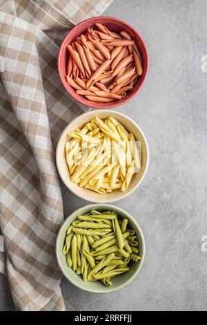Fusilli pugliesi. Pasta tricolore italiana contorta nel recipiente. Vista dall'alto. Foto Stock