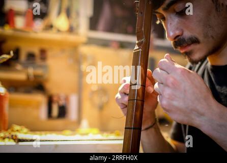 220418 -- ISTANBUL, 18 aprile 2022 -- Un artigiano realizza uno strumento turco tradizionale in un laboratorio a Istanbul, in Turchia, il 17 aprile 2022. Foto di /Xinhua TURCHIA-ISTANBUL-ARTIGIANATO UnalxCam PUBLICATIONxNOTxINxCHN Foto Stock