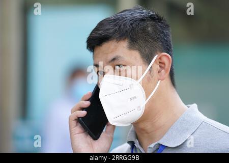 220522 -- PECHINO, 22 maggio 2022 -- Mei Xiaodong fa una telefonata per controllare l'ordine dei medicinali di un residente nel distretto di Chaoyang a Pechino, capitale della Cina, 21 maggio 2022. Mei Xiaodong, 35 anni, è un lavoratore governativo del distretto di Chaoyang di Pechino. Mei è stato inviato per unirsi al lavoro del personale in prima linea in una comunità nella lotta contro la COVID-19, aiutando i residenti sotto quarantena domestica ad acquistare farmaci per le malattie croniche. I lavoratori comunitari, i medici e i volontari si assumono la responsabilità di valutare, acquistare e consegnare i medicinali ordinati dai residenti tramite Wechat o telefonate. Da allora Foto Stock