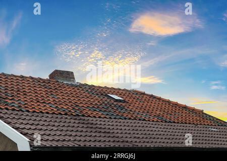 Finestrino del tetto in stile Velux con piastrelle del tetto scure Foto Stock