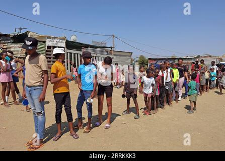 220912 -- WINDHOEK, 12 settembre 2022 -- bambini in fila per ricevere cibo al Needy Hearts Soup Kitchen di Hakahana, un insediamento informale a Windhoek, Namibia, il 12 settembre 2022. PER ANDARE CON caratteristiche: La cucina della zuppa porta cura, amore per i bambini di insediamento informale della NAMIBIA foto di /Xinhua NAMIBIA-WINDHOEK-NEEDY HEARTS ZUPPA KITCHEN NdalimpingaxIita PUBLICATIONxNOTxINxCHN Foto Stock