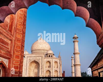 Una vista del Taj Mahal ad Agra attraverso uno stile tradizionale dell'arco moghul. Foto Stock