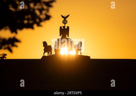 Berlino, Germania. 10 settembre 2023. Il sole sorge dietro la porta di Brandeburgo. Crediti: Paul Zinken/dpa/Alamy Live News Foto Stock