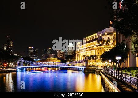 Singapore CBD, Singapore, 22 novembre 2019: Il Fullerton Hotel e il Cavenagh Bridge sul fiume Singapore in una serata limpida Foto Stock