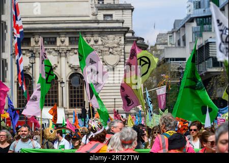 LONDRA - 22 aprile 2023: Il clima di Londra: I manifestanti XR convergono in città, sullo sfondo suggestivo di colorate bandiere di protesta, und Foto Stock