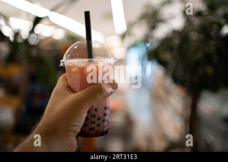 Bevanda tradizionale del concetto di Taiwan. Donna che tiene a mano il tè a bolle di latte con perle di tapioca Foto Stock