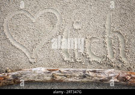 Un cuore trascinato nella sabbia, e la parola cordial Foto Stock