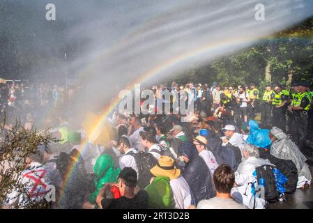 L'Aia, Olanda meridionale, Paesi Bassi. 9 settembre 2023. La polizia olandese spruzza gli attivisti del clima con cannoni ad acqua. Il 9 settembre 2023, gli attivisti della ribellione di estinzione bloccarono l'autostrada A12 che attraversava il centro dell'Aia, nei Paesi Bassi. La protesta era in opposizione ai miliardi di euro del governo olandese in sovvenzioni all'industria dei combustibili fossili. (Immagine di credito: © James Petermeier/ZUMA Press Wire) SOLO USO EDITORIALE! Non per USO commerciale! Foto Stock