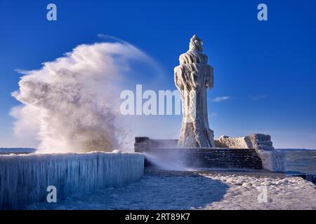 Faro ghiacciato e molo nelle tempeste giornate invernali Foto Stock