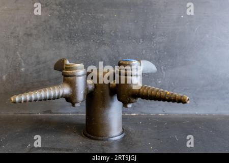 Valvola del gas su un tavolo da laboratorio in resina nera in un'aula di scienze delle scuole superiori. Foto Stock