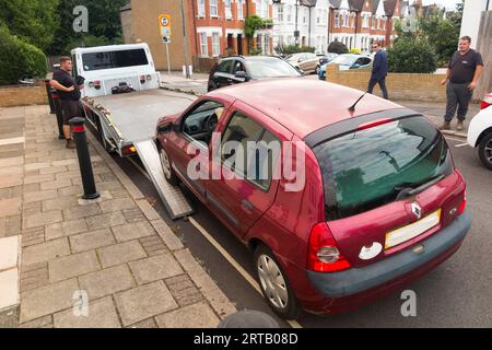 Un'auto Renault Clio Diesel del 2003 viene portata via dalla società di veicoli rottamati in quanto non conforme alla ULEZ (zona a bassissima emissione) estesa introdotta dal sindaco di Londra Sadiq Khan. Il proprietario, una madre di tre figli, riceve un assegno per figli e dovrebbe ricevere una certa compensazione finanziaria. (135) Foto Stock