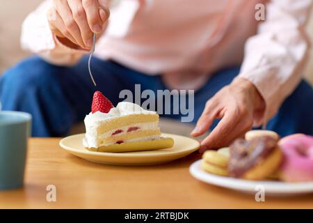 Uomo giapponese che mangia a casa Foto Stock