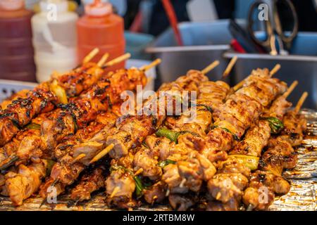 Grigliate con spiedino di carne e kebab presso la tradizionale bancarella del mercato notturno, delizioso cibo di strada in Corea del Sud. Foto Stock