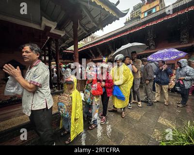 Kathmandu, Bagmati, Nepal. 12 settembre 2023. Le persone si mettono in fila per ricevere offerte distribuite dai devoti buddisti nelle docce a pioggia durante il festival Pancha Dan a Kathmandu, Nepal, 12 settembre 2023. Pancha Dan, la festa dei cinque doni estivi, è osservata dai buddisti donando cinque elementi tra cui cereali di grano, cereali di riso, sale, denaro e frutta. (Immagine di credito: © Sunil Sharma/ZUMA Press Wire) SOLO USO EDITORIALE! Non per USO commerciale! Crediti: ZUMA Press, Inc./Alamy Live News Foto Stock